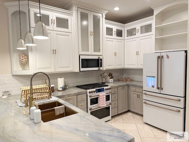 107 E Palm St Unit B, South Padre Island, TX 78597 - kitchen featuring light stone countertops, tasteful backsplash, decorative light fixtures, white cabinetry, and white appliances