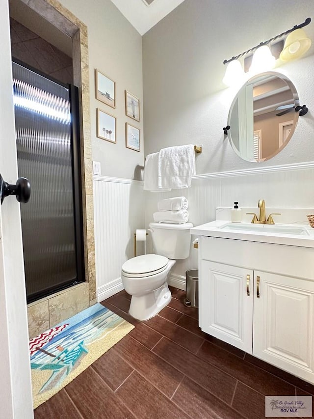 107 E Palm St Unit B, South Padre Island, TX 78597 - full bath featuring vanity, wood tiled floor, toilet, a stall shower, and wainscoting