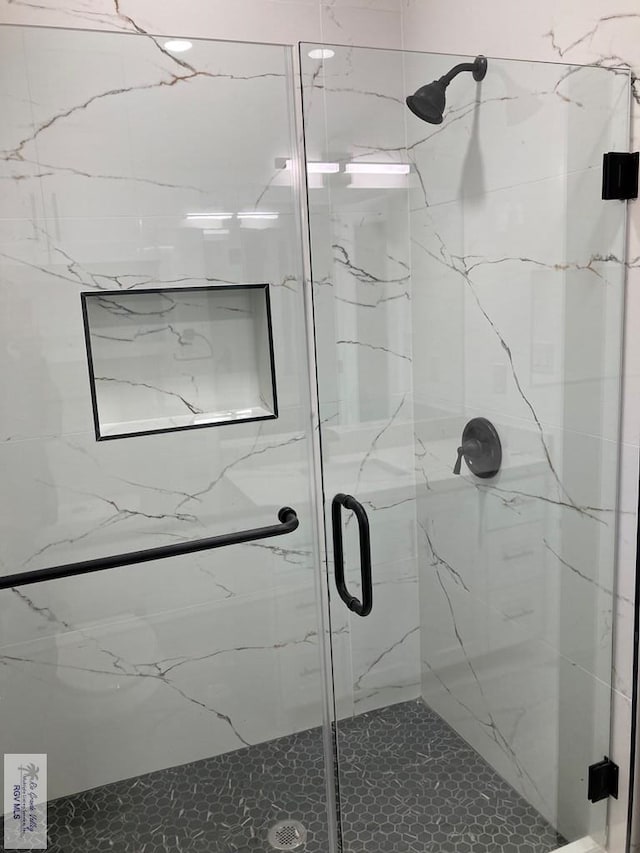 bathroom with a shower with door