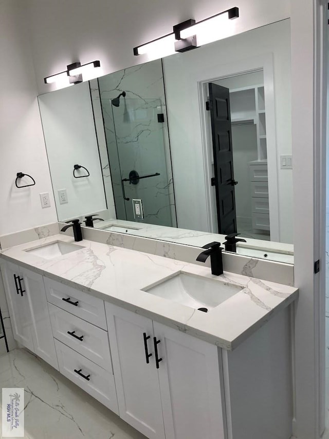 bathroom featuring vanity and a shower with shower door