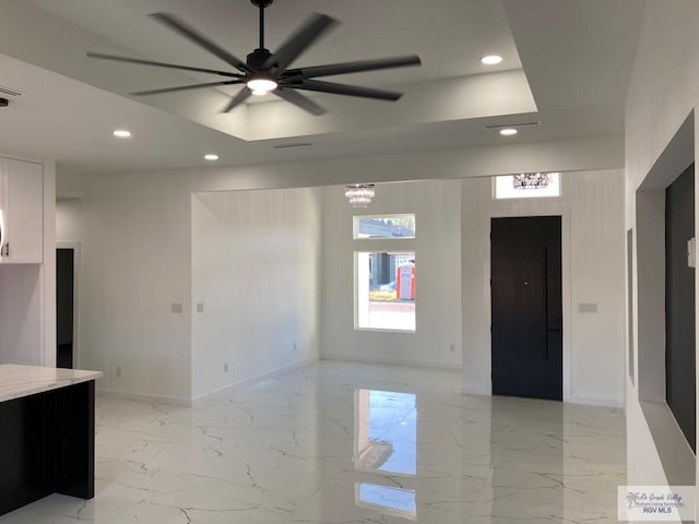 interior space with ceiling fan with notable chandelier