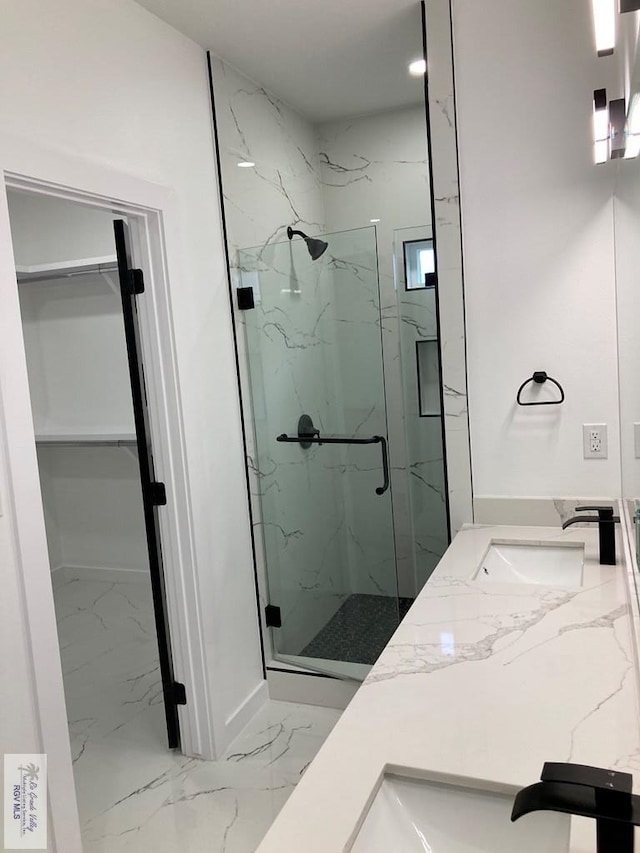 bathroom with vanity and a shower with shower door