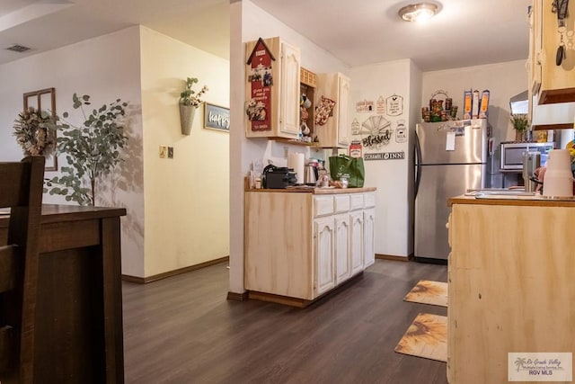 kitchen featuring appliances with stainless steel finishes and dark wood-type flooring