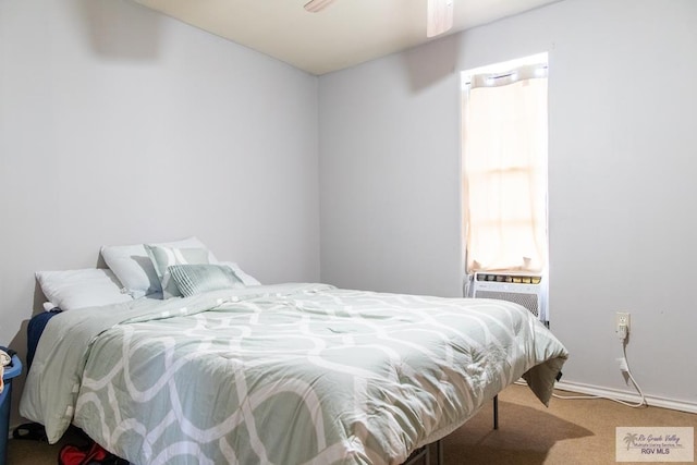 bedroom with carpet, ceiling fan, and cooling unit