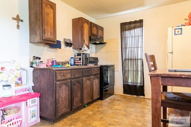 kitchen featuring backsplash, black / electric stove, dark brown cabinets, and white refrigerator