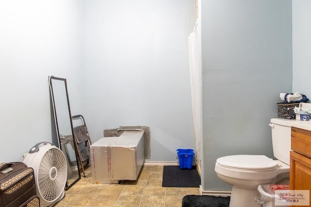 bathroom featuring tile patterned floors, vanity, and toilet