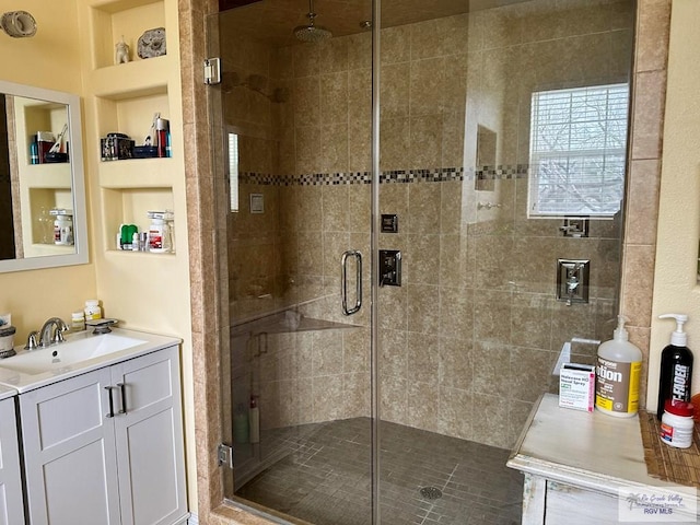 bathroom with vanity and an enclosed shower