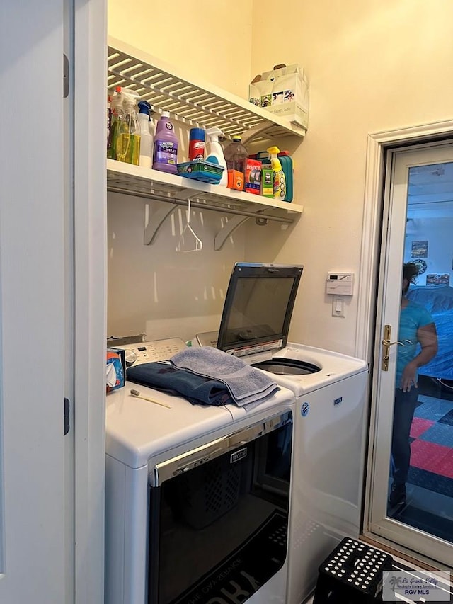 clothes washing area with washer and dryer