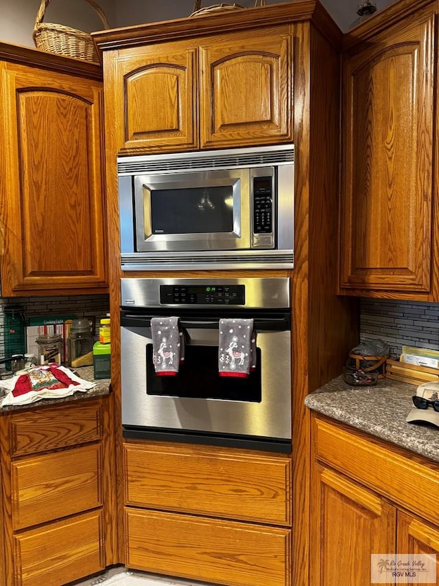 kitchen with appliances with stainless steel finishes and tasteful backsplash