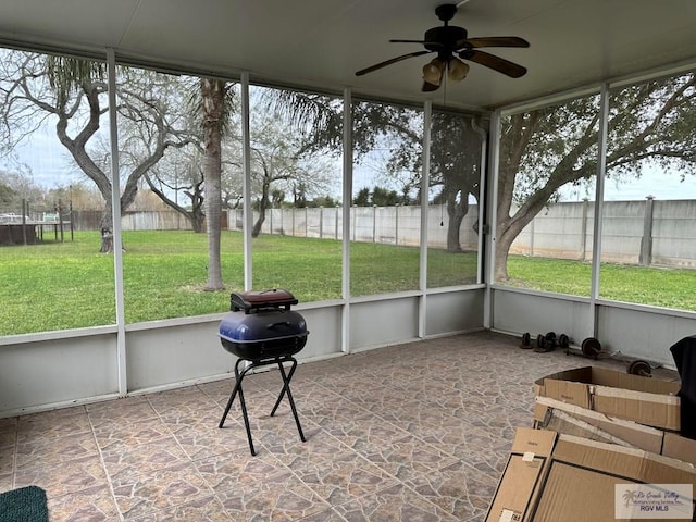 sunroom featuring ceiling fan