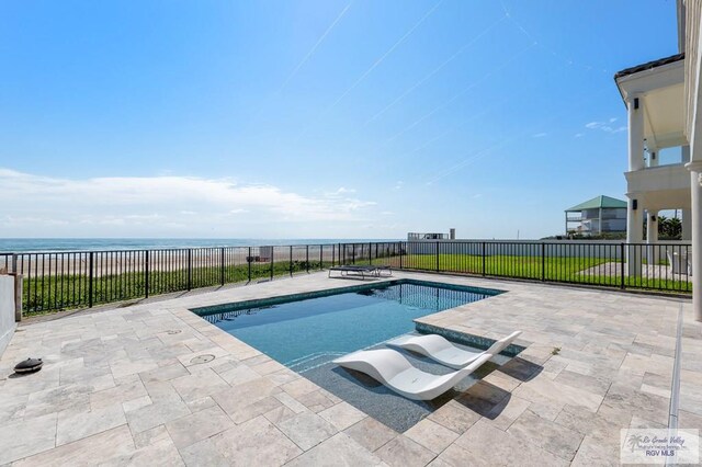 view of pool with a water view and a patio area