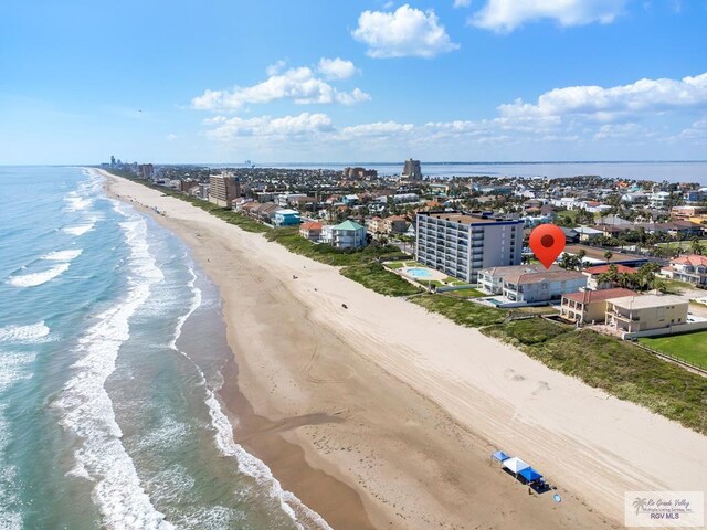 aerial view with a water view and a beach view