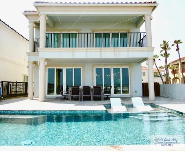 rear view of property with a balcony and a patio area