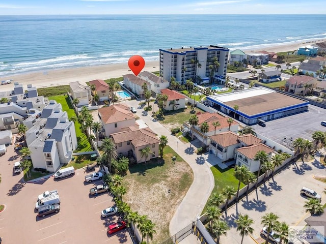 bird's eye view featuring a water view and a view of the beach