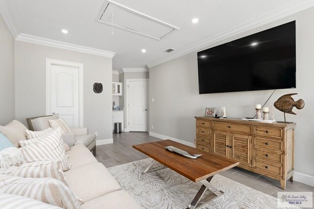 living room featuring light wood-type flooring and ornamental molding