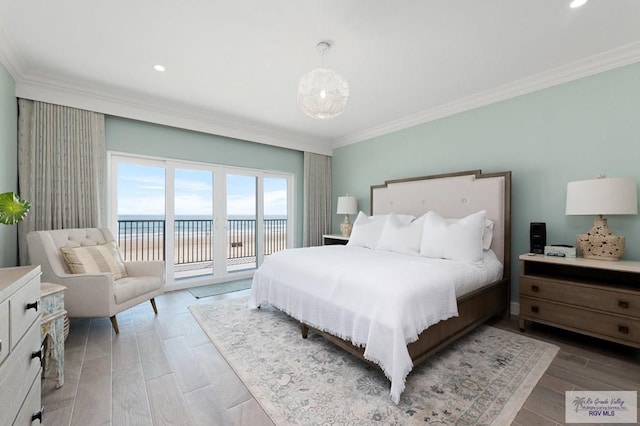 bedroom featuring access to outside, a water view, wood-type flooring, and ornamental molding