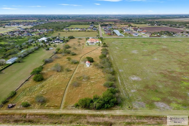 birds eye view of property with a rural view