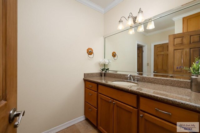 bathroom featuring vanity, tile patterned floors, and crown molding