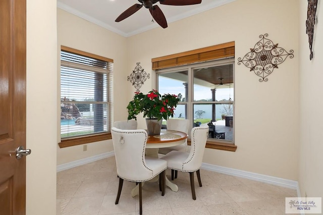 dining area with ceiling fan and ornamental molding