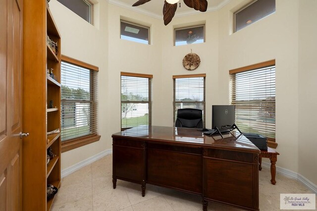 office space with light tile patterned floors, a wealth of natural light, crown molding, and ceiling fan