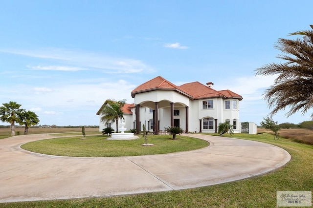 mediterranean / spanish-style house with a front yard