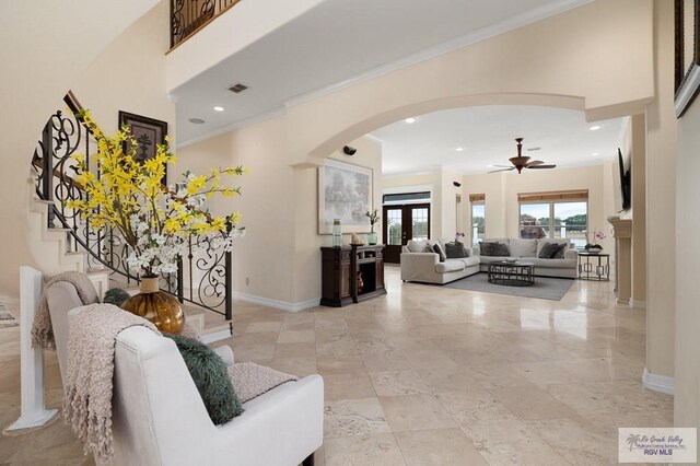 living room with ceiling fan, french doors, and ornamental molding