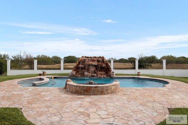 view of pool with pool water feature