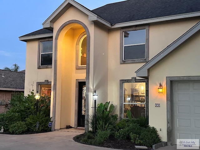 view of exterior entry with a garage