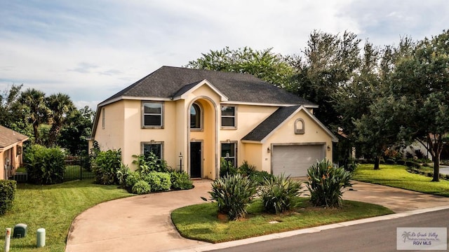 view of front of home featuring a garage and a front lawn