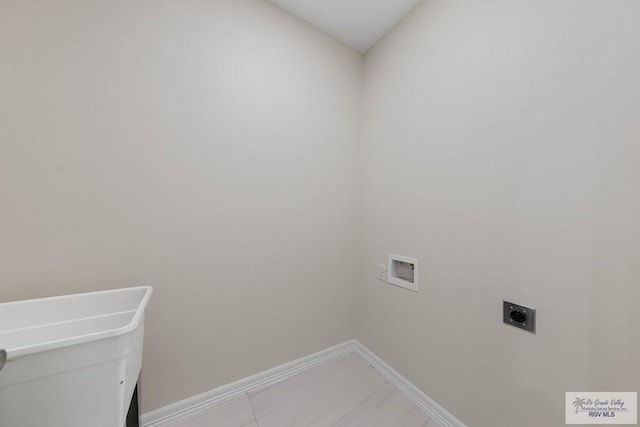 laundry area with baseboards, laundry area, washer hookup, and hookup for an electric dryer