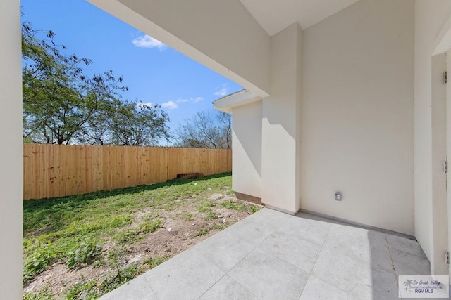 view of yard featuring fence and a patio