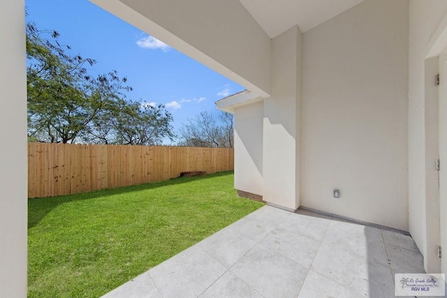 view of yard featuring fence and a patio