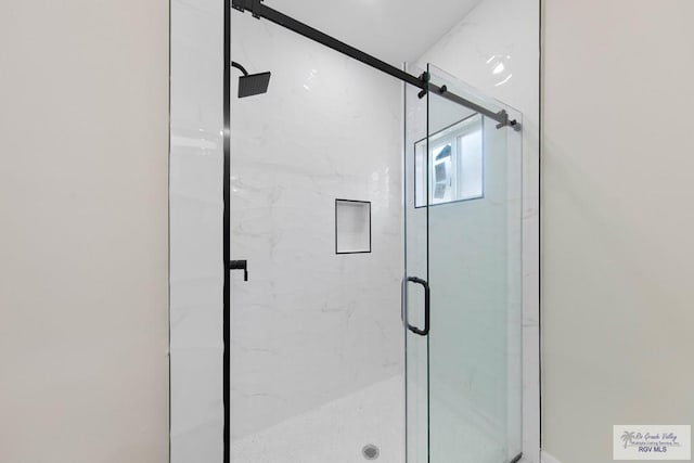 full bath with a marble finish shower