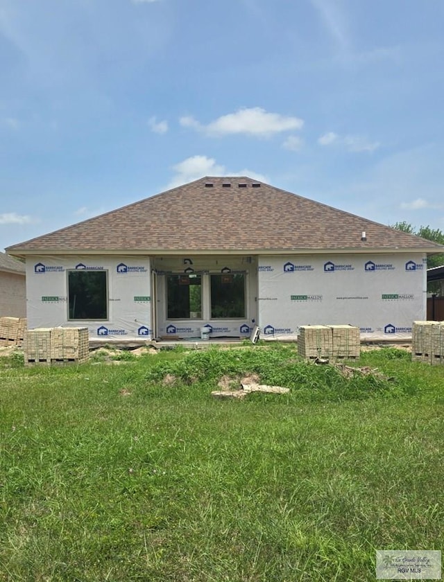 back of property with a yard