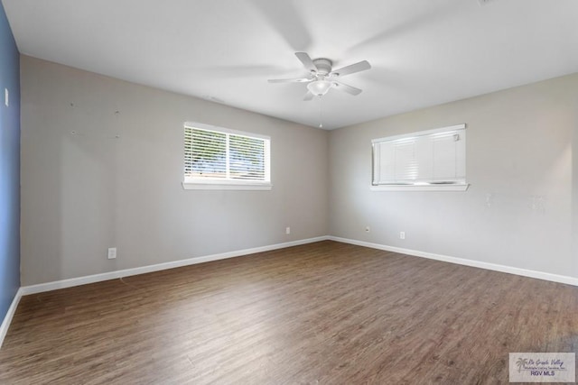 unfurnished room with ceiling fan, wood finished floors, and baseboards
