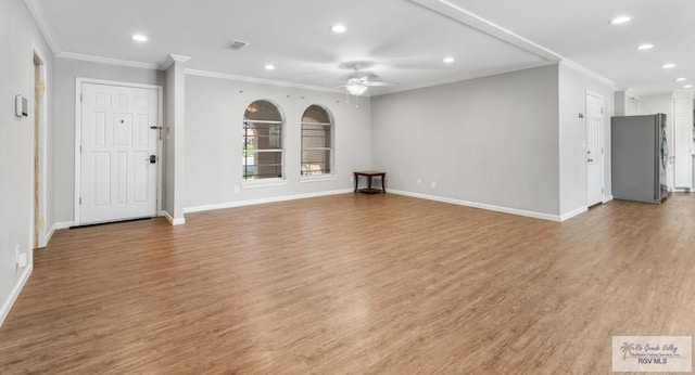 unfurnished living room featuring a ceiling fan, recessed lighting, ornamental molding, baseboards, and wood finished floors