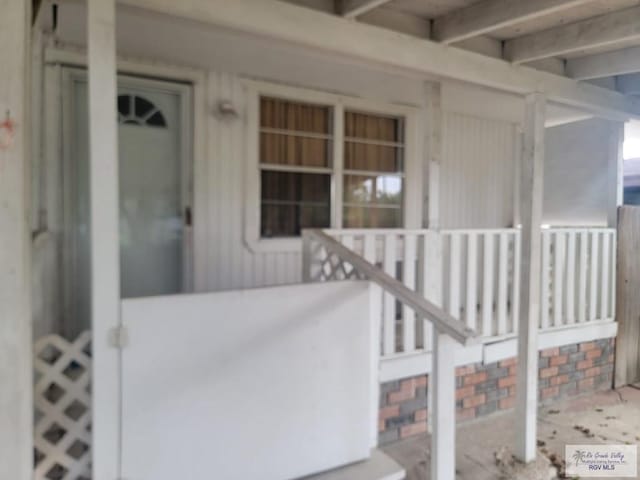 property entrance featuring covered porch