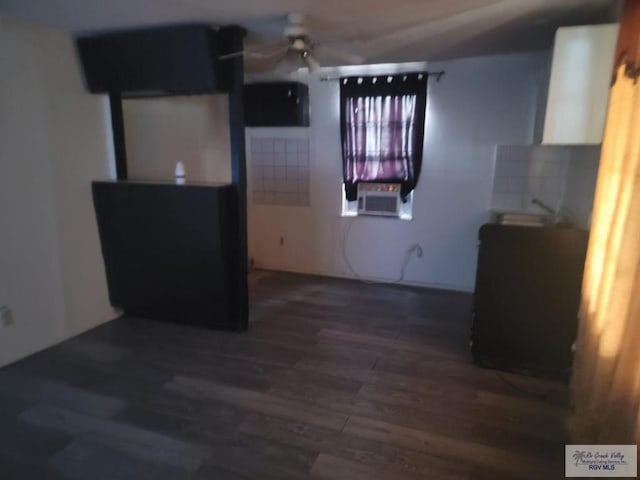 interior space with backsplash, cooling unit, ceiling fan, and dark wood-type flooring