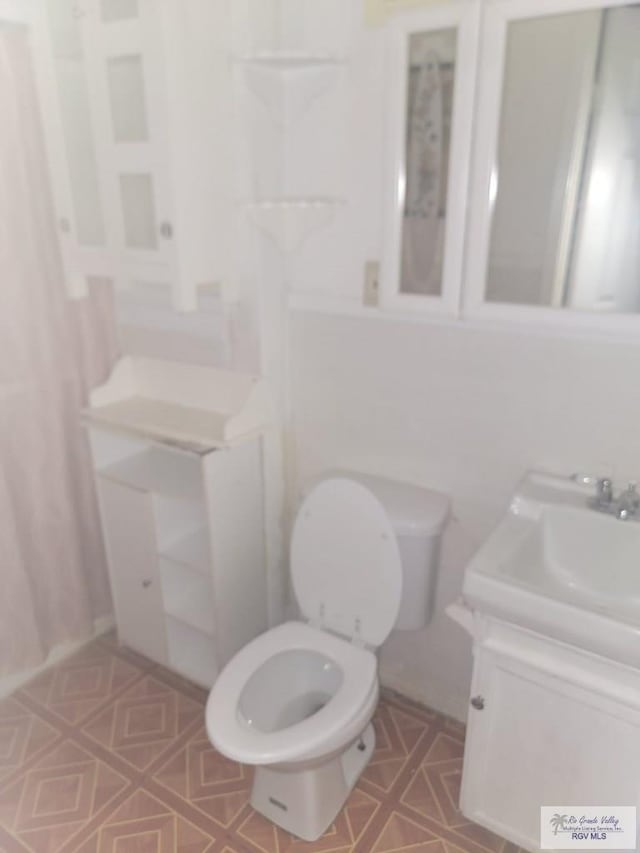 bathroom featuring vanity and toilet