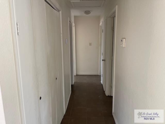 hallway featuring dark tile patterned flooring