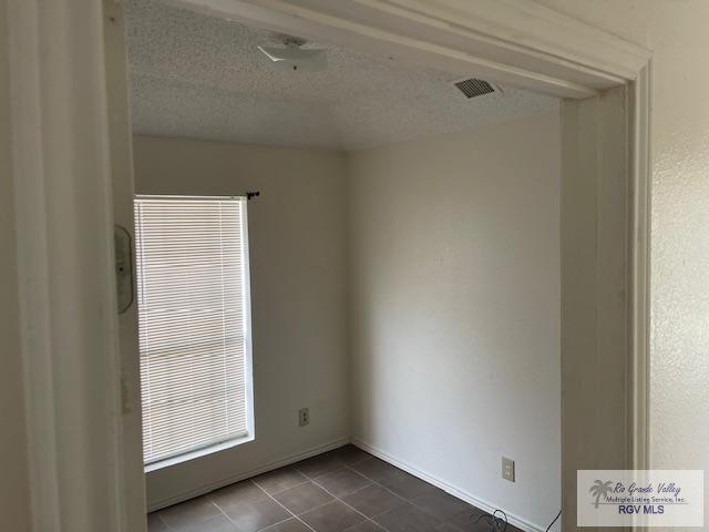 unfurnished room featuring tile patterned flooring