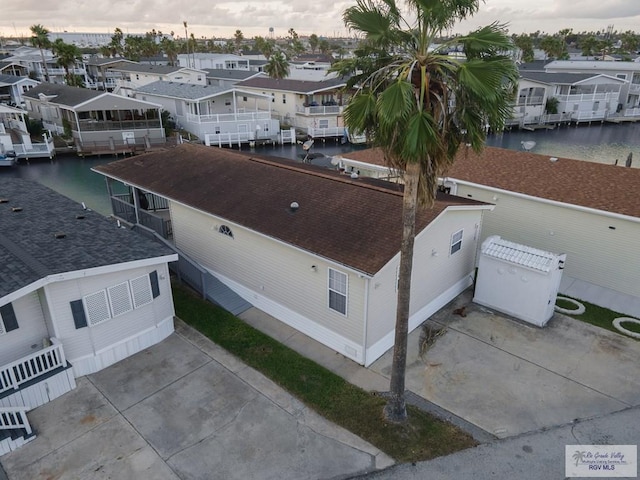 birds eye view of property with a residential view and a water view