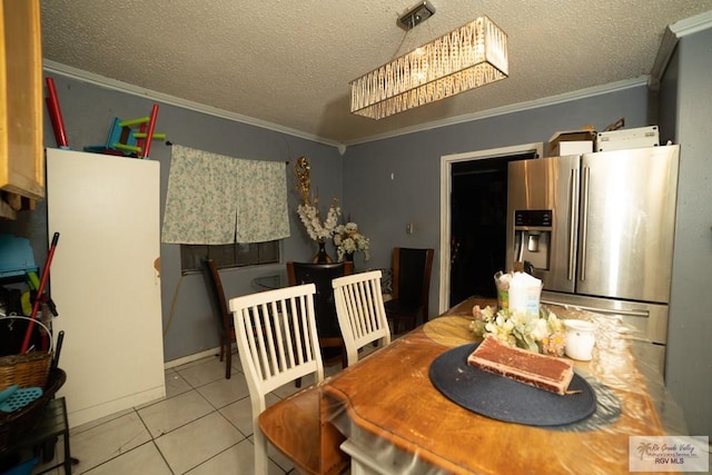 dining area featuring crown molding, light tile patterned floors, and a textured ceiling