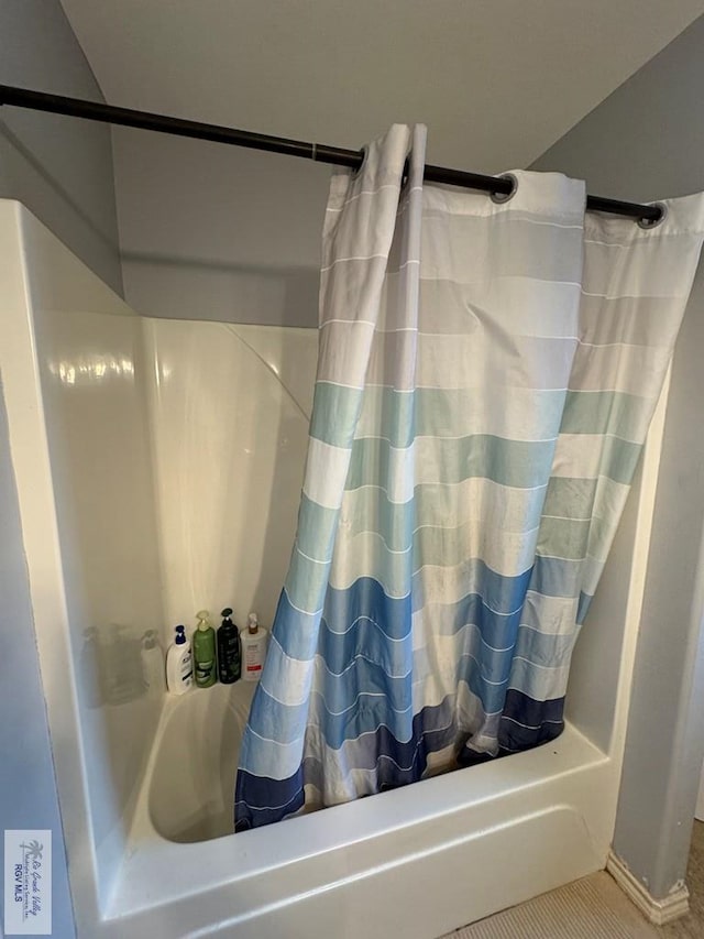 bathroom with shower / bath combination with curtain