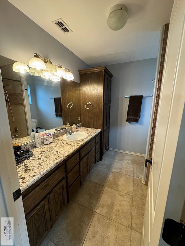 bathroom featuring tile patterned floors, vanity, and toilet