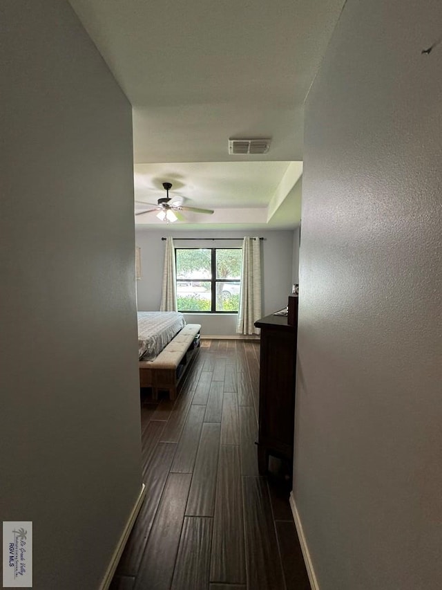 unfurnished bedroom with ceiling fan and dark hardwood / wood-style flooring