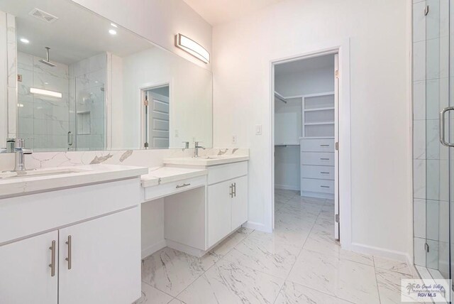 bathroom with vanity and a shower with shower door