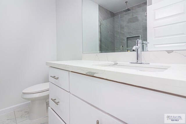 bathroom with vanity, toilet, and an enclosed shower