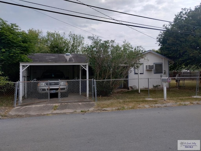 335 Edwards St, San Benito, TX 78586 - view of front of property with an AC wall unit and a detached carport