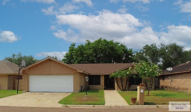 122 Regency Ct, Harlingen, TX 78550 - ranch-style home with an attached garage, concrete driveway, a front lawn, and stucco siding